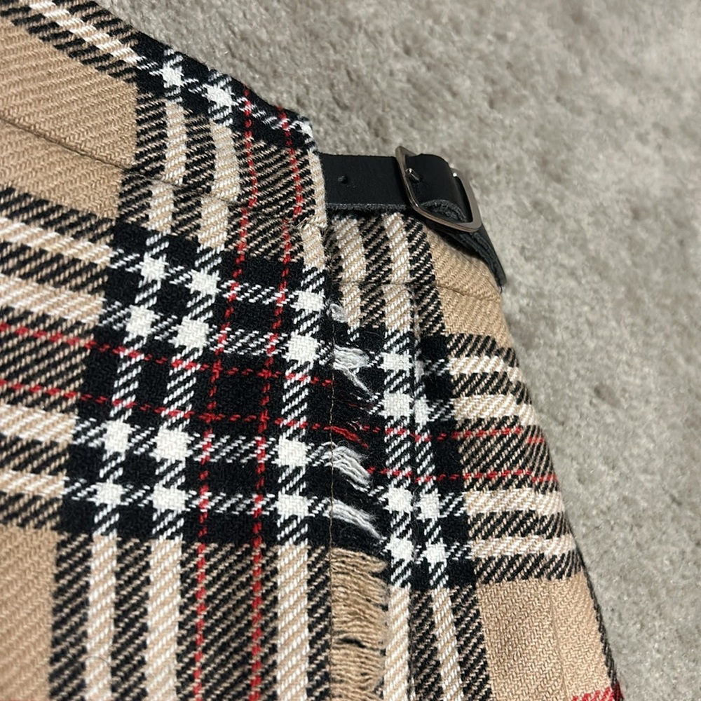 Toddler plaid skirt measures approximately 10 1/2 inches across the waist. - Picture 3 of 8